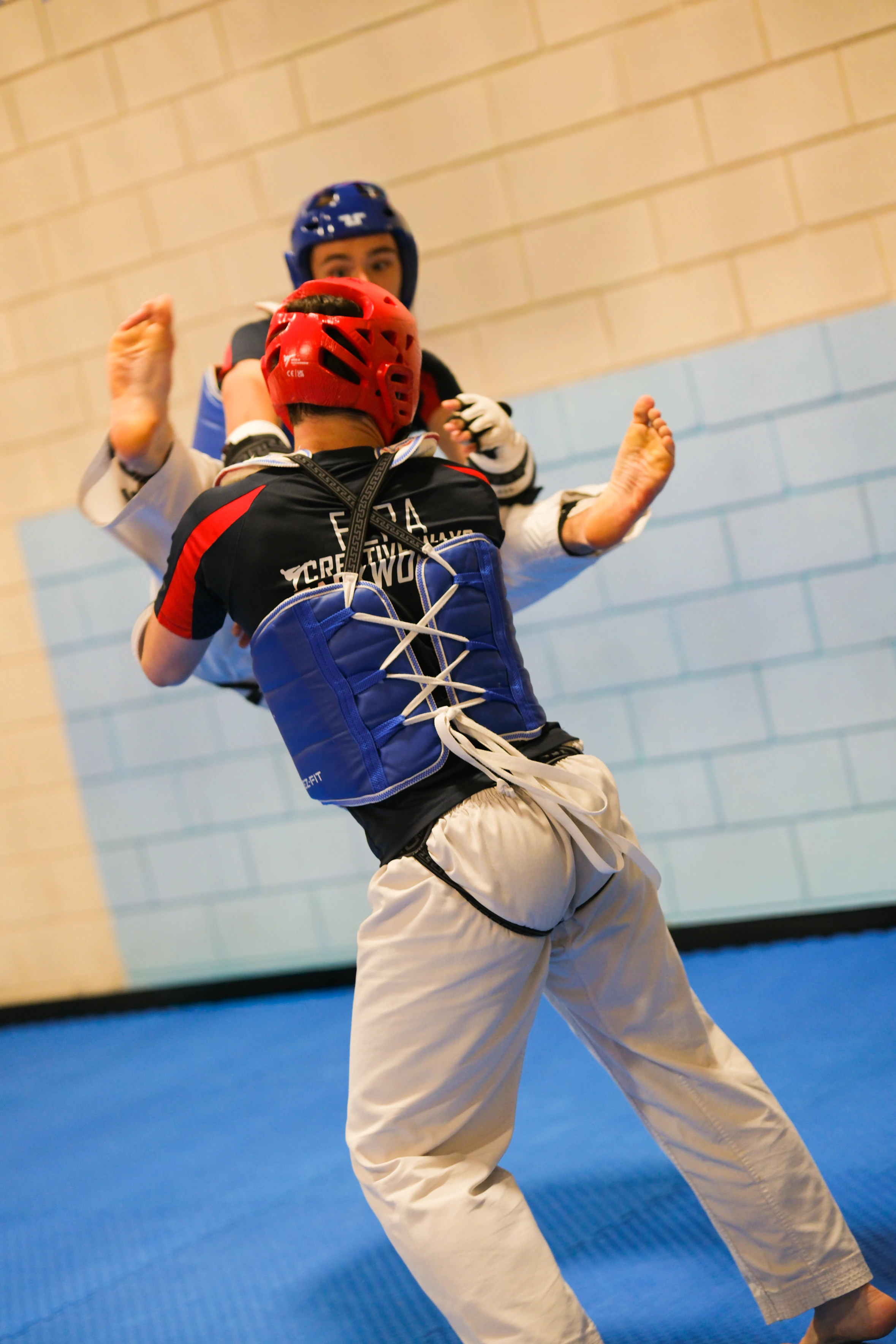 Students wearing protective kit during sparring practice