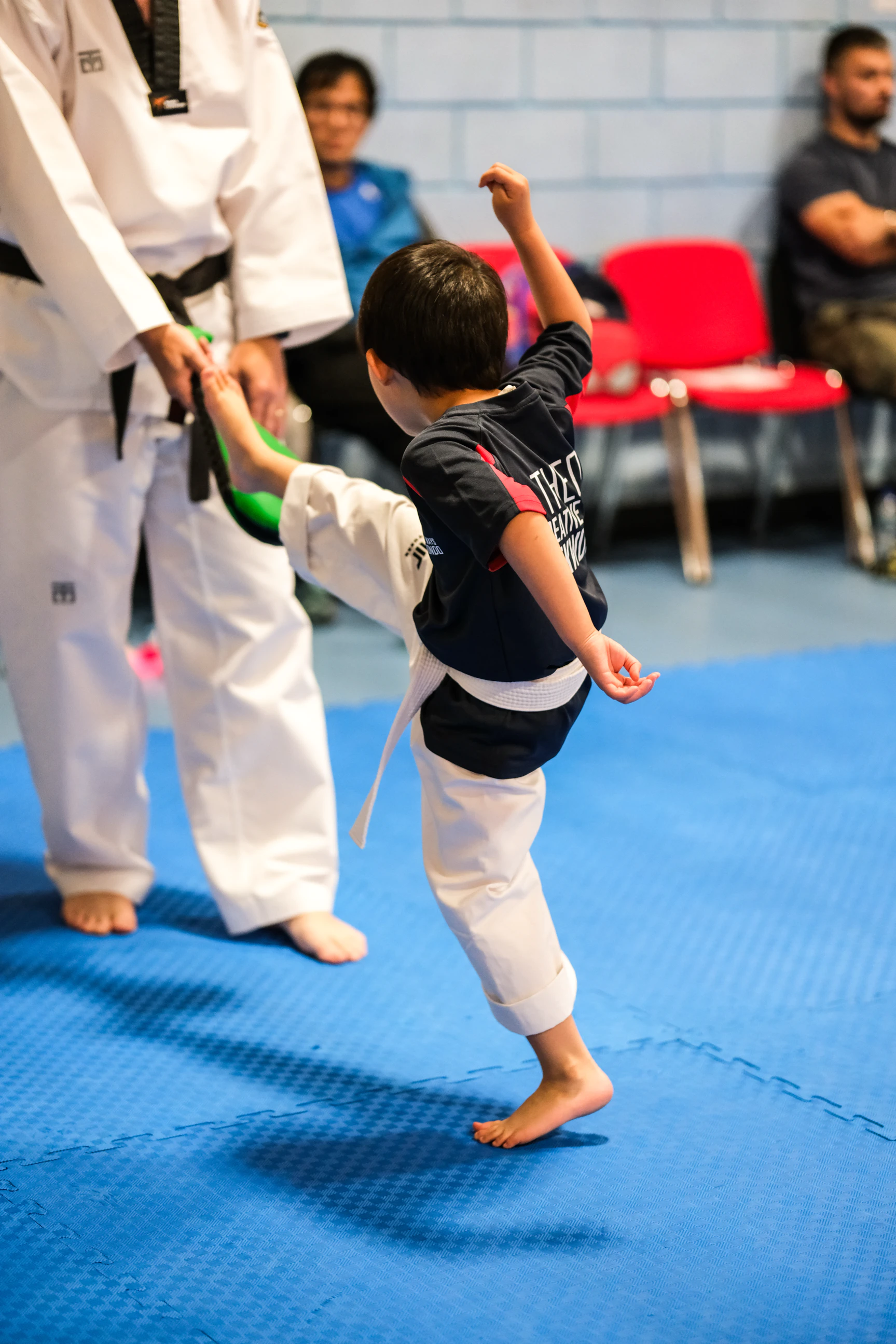 Young Titans student standing on the mats during a Creative Ways Taekwondo class